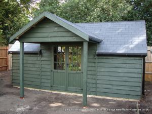 Heavy Duty Workshop bespoke 19x8 with Hip Roofed Front Canopy, Double Georgian Doors, Grey Felt Tiles, Featheredge Cadding with Painted Finish.