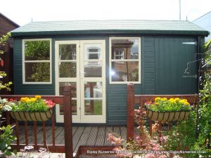 Deluxe Apex Bespoke 14x8, Extra Height, Richmond Doors, Double Glazed Sash Windows, Partitioned Shed Area, Felt Tiled Roof and Topiary Green Finish.